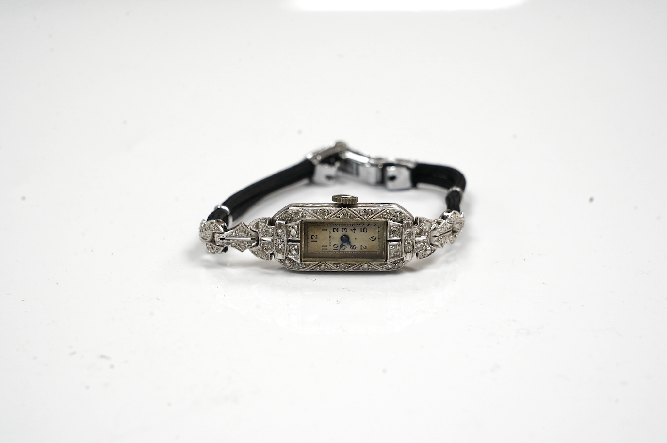 A lady's mid 20th century Buren white metal (stamped platinum) and diamond cluster set manual wind cocktail watch, on a twin fabric strap, gross weight 15.3 grams. Condition - poor to fair